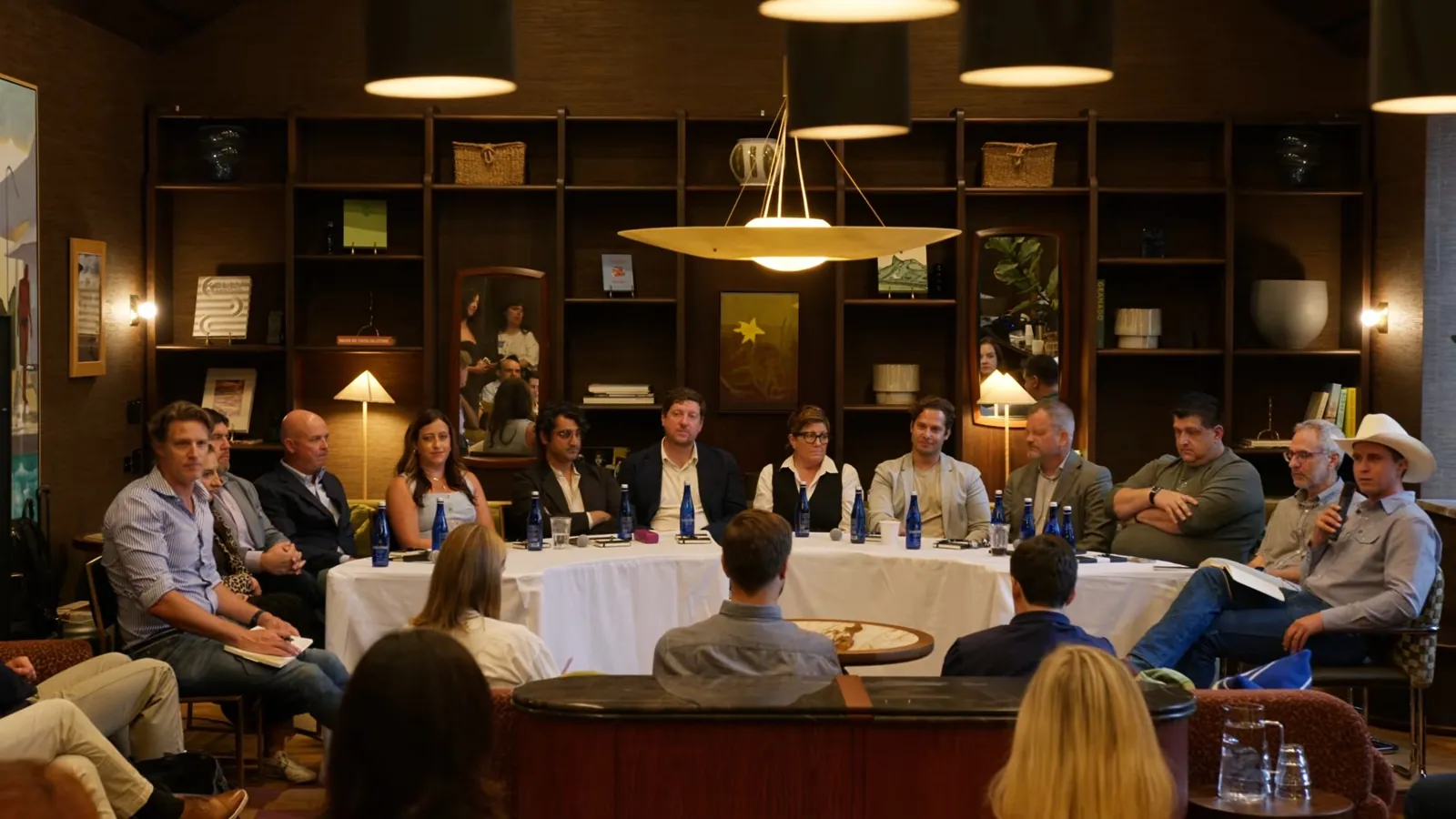 The full roundtable across both tables under the hanging lamp