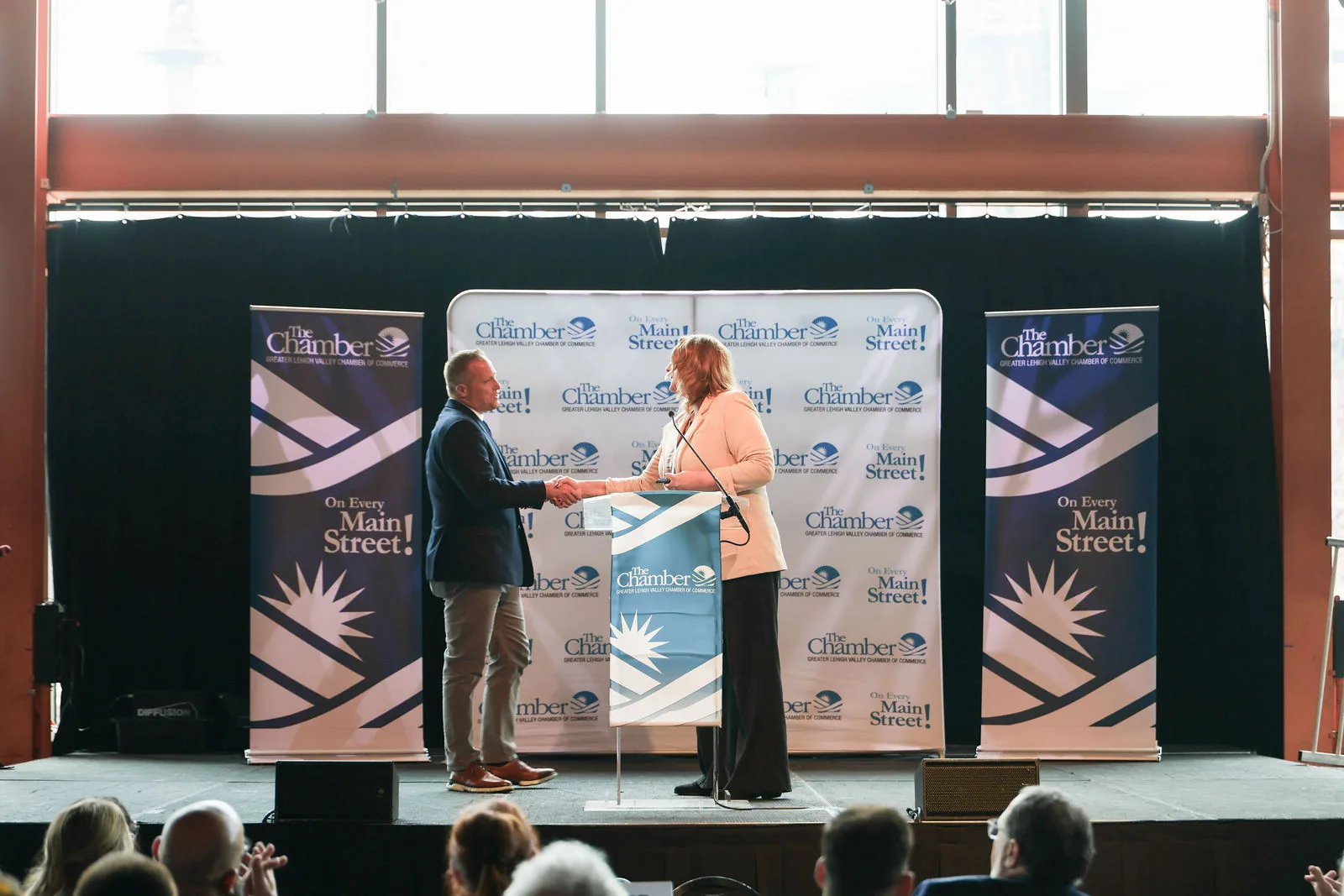 The Manufacturer of the Year award handshake on stage
