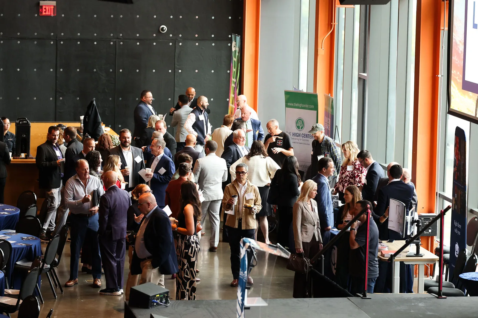 Attendees networking in the lobby before the program