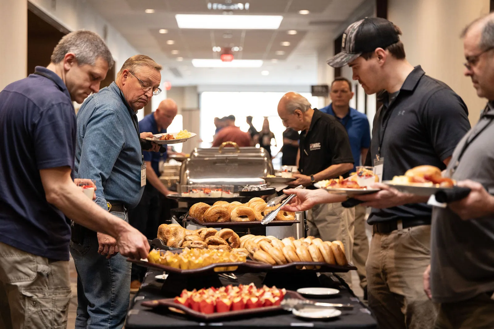 Attendees filling their plates at the breakfast buffet