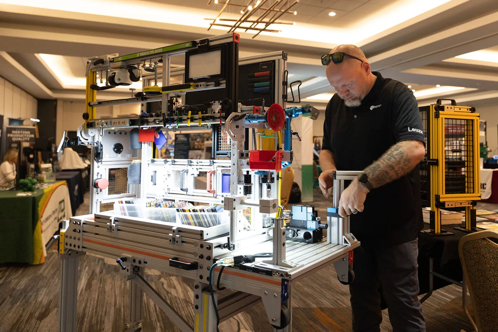 An exhibitor adjusting an automation demo cell