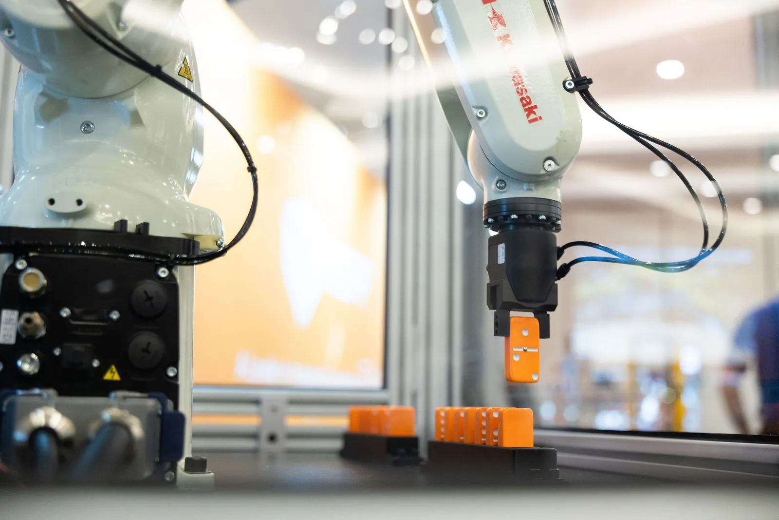Close-up of the robot gripper placing orange dominoes