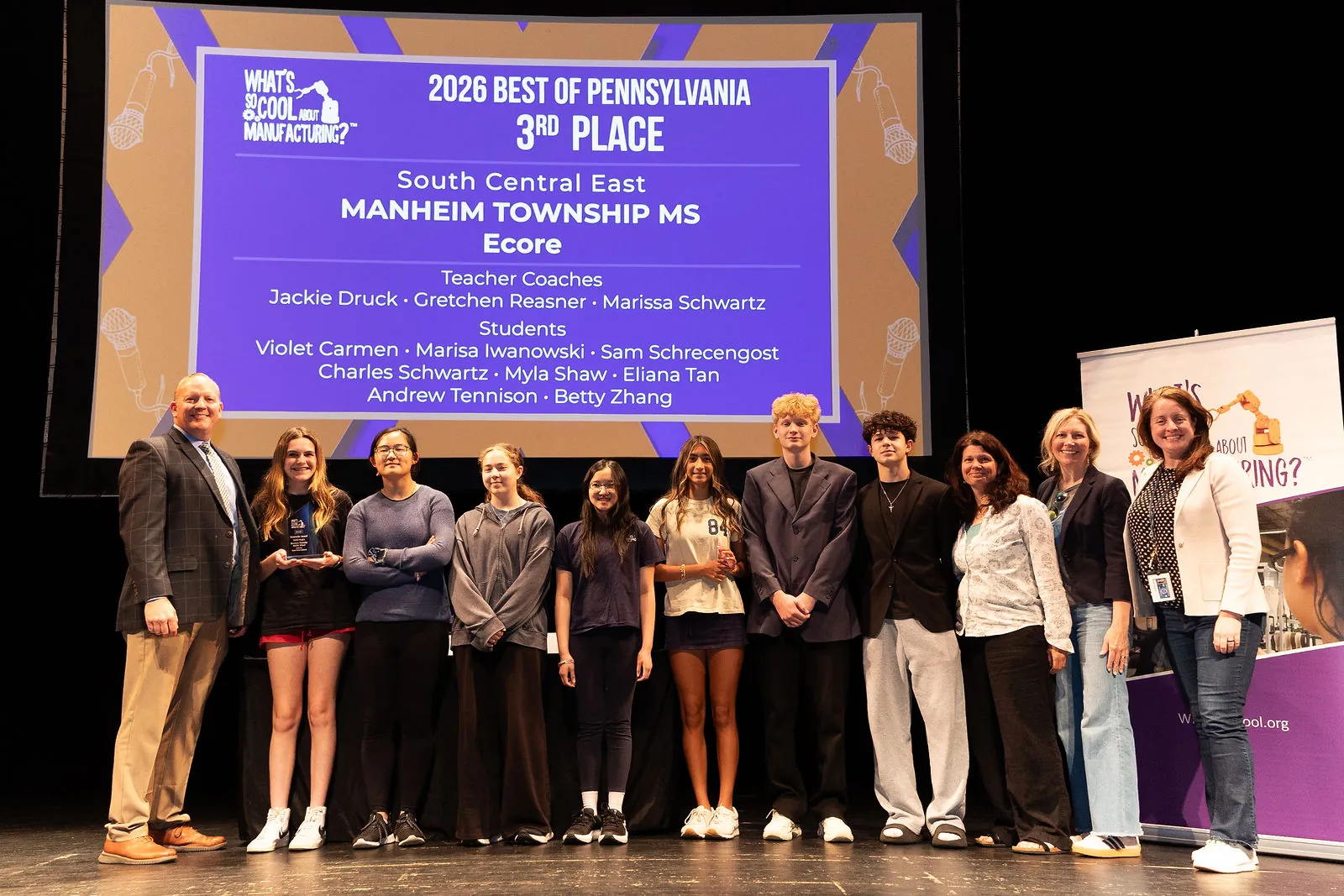 The Manheim Township Middle School team on stage in front of the third place slide