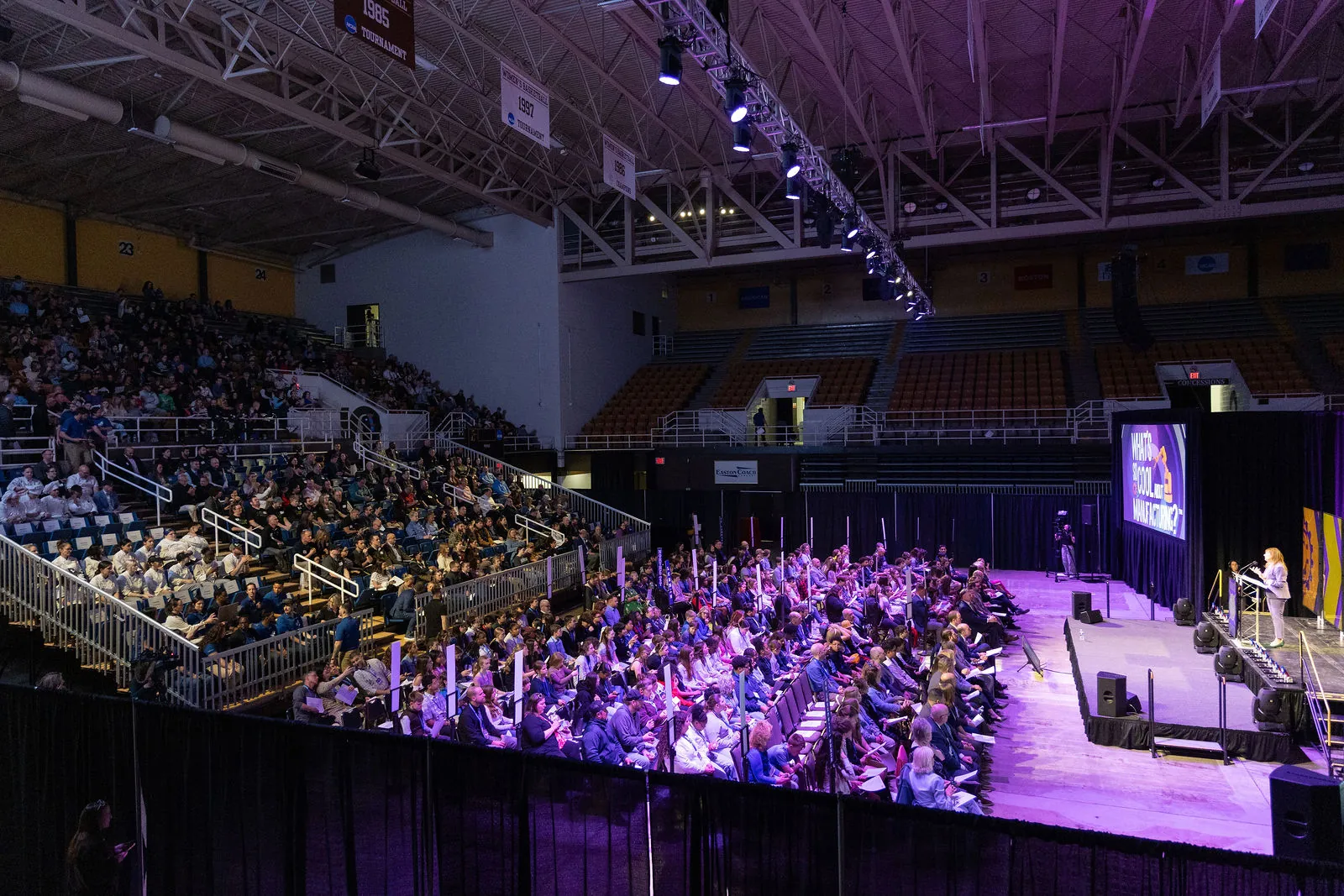 Wide view of Stabler Arena from the upper corner, with the stands full and the stage lit purple
