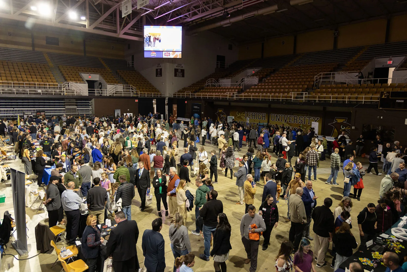The pre-show expo filling the arena floor, seen from the stands